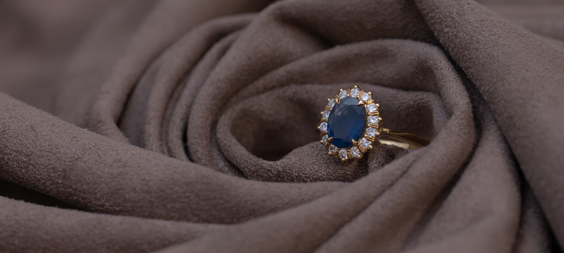 Oval blue sapphire ring with diamond halo